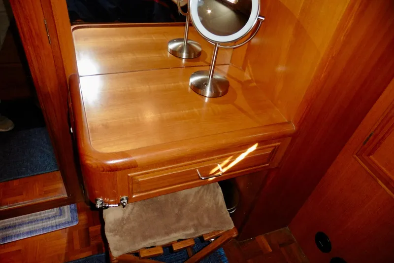Slide: The Image of Interior view of 2000 Ocean Alexander 423 Classico yacht, featuring wooden trim and storage space. - 72