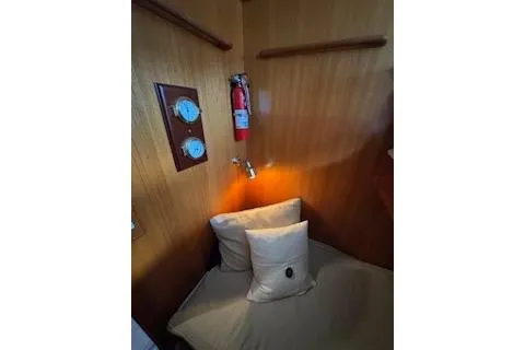 Slide: The Image of Cozy cabin interior of 1997 Ocean Alexander 426 Classico with wooden paneling and fire extinguisher. - 90