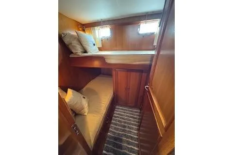 Slide: The Image of 1997 Ocean Alexander 426 Classico cabin with wooden interior and bunk beds. - 91