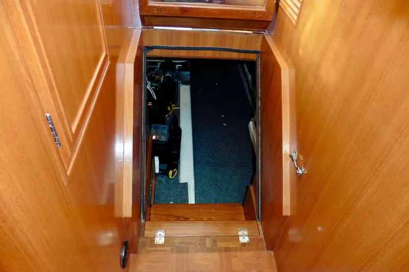 Slide: The Image of Engine room access on 2000 Ocean Alexander 423 Classico yacht, featuring wooden interior. - 92