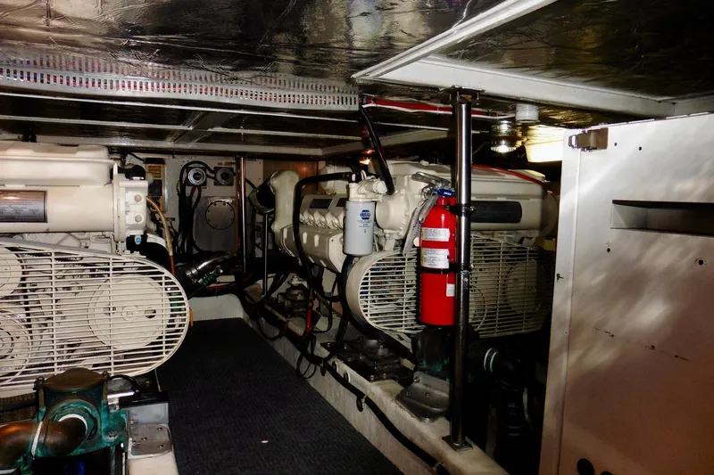 Slide: The Image of Engine room of 2000 Ocean Alexander 423 Classico yacht with visible machinery and fire extinguisher. - 93