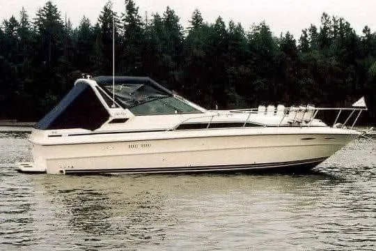 The Image of 1986 Sea Ray 340 Sundancer docked at marina, sunny day. - 0