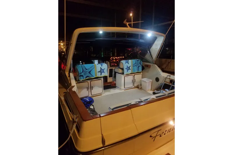 Slide: The Image of 1986 Sea Ray 340 Sundancer docked in a covered marina. - 10