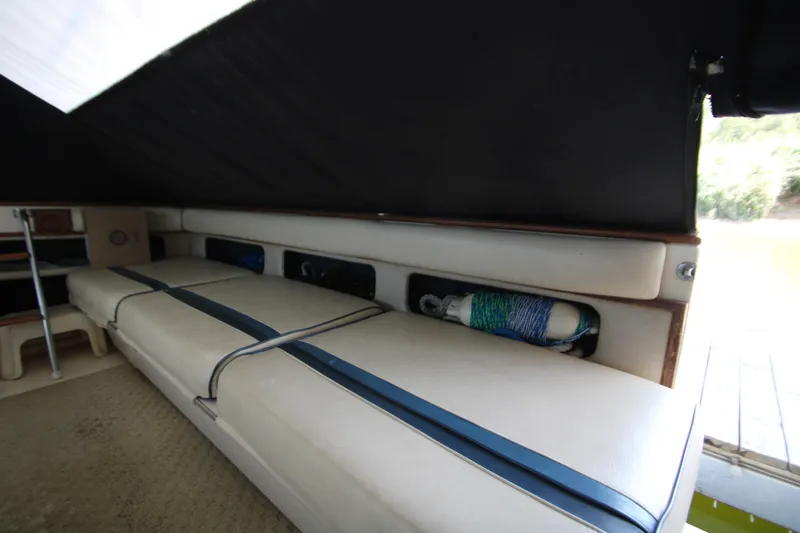 Slide: The Image of 1986 Sea Ray 340 Sundancer boat interior with starfish-themed seat covers at night. - 12