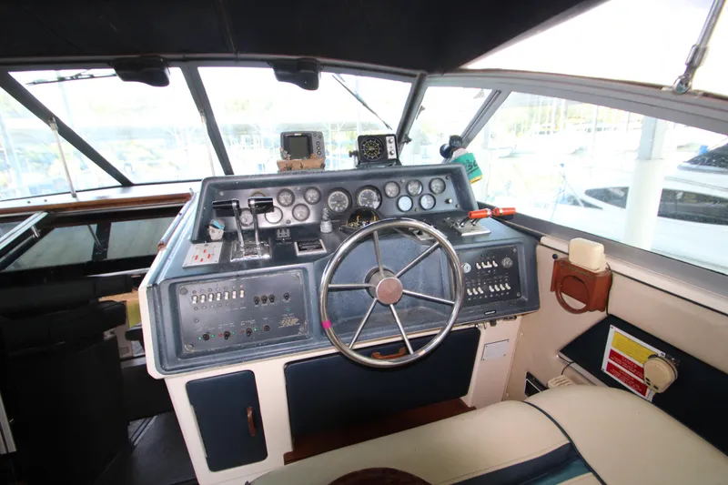 Slide: The Image of 1986 Sea Ray 340 Sundancer interior with cushioned seating and storage compartments. - 14