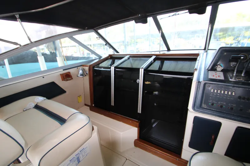 Slide: The Image of Interior of 1986 Sea Ray 340 Sundancer boat showing helm and seating area. - 15