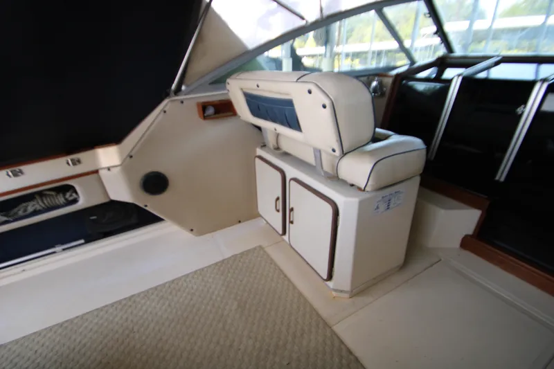 Slide: The Image of 1986 Sea Ray 340 Sundancer helm with steering wheel and control panel. - 16