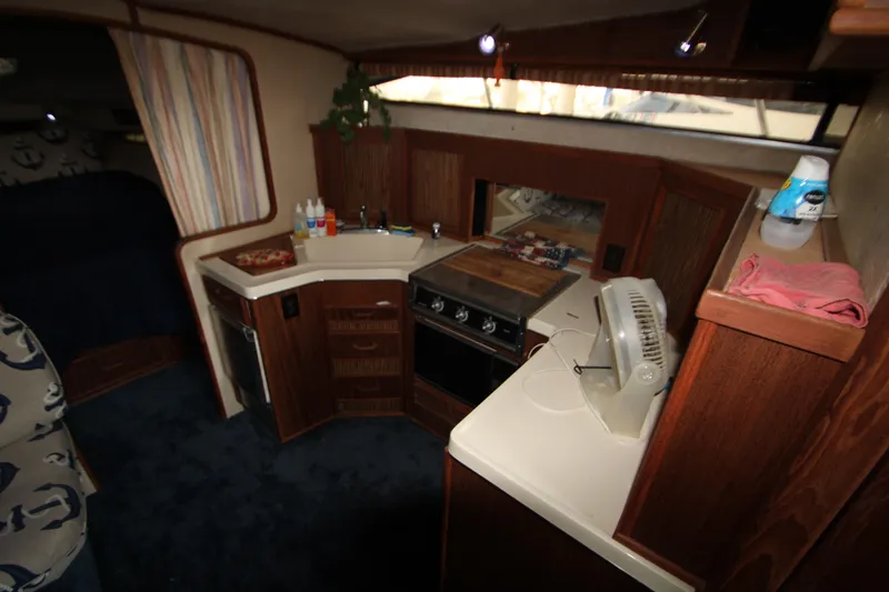 Slide: The Image of 1986 Sea Ray 340 Sundancer helm with cushioned seating and control panel. - 19