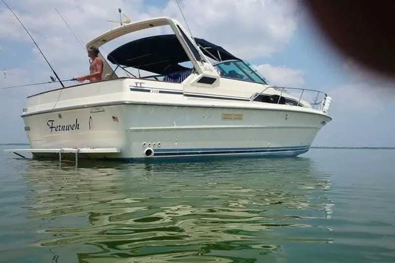 Slide: The Image of Interior cabin of 1986 Sea Ray 340 Sundancer with nautical-themed decor and cozy bedding. - 2