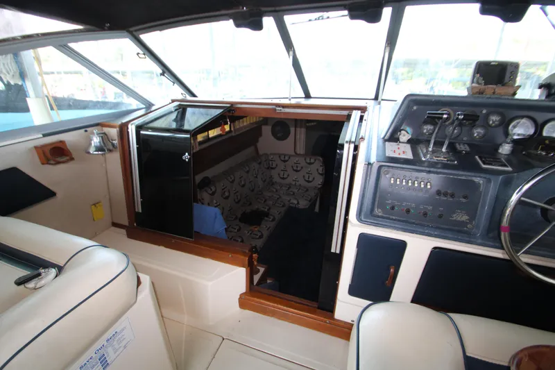 Slide: The Image of 1986 Sea Ray 340 Sundancer cabin interior with helm and seating area. - 20