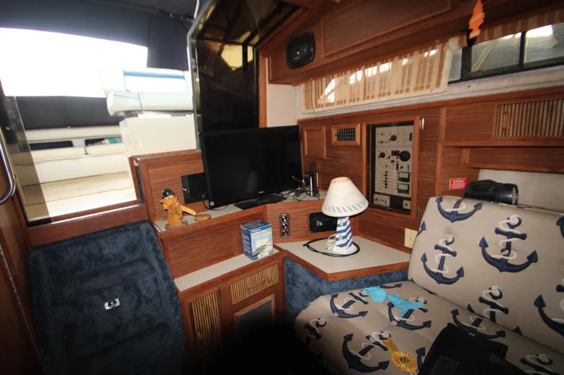 Slide: The Image of 1986 Sea Ray 340 Sundancer interior kitchen with stove, sink, and wooden cabinetry. - 22
