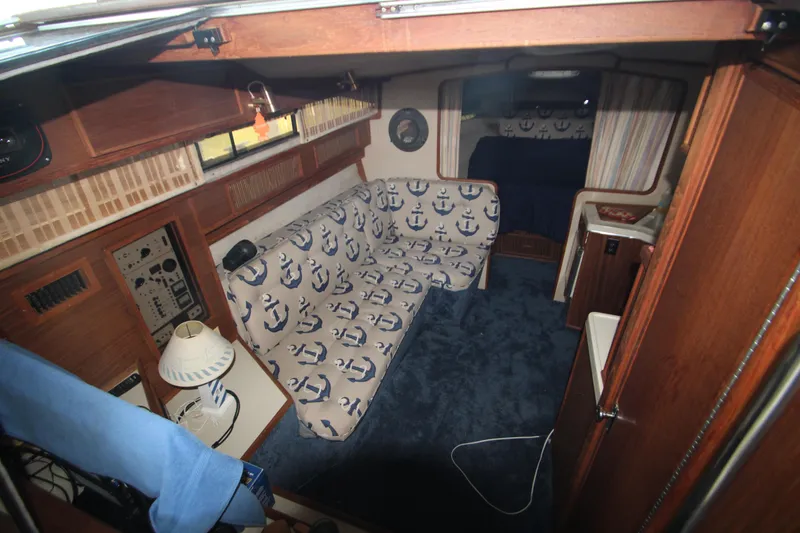 Slide: The Image of Interior of 1986 Sea Ray 340 Sundancer with nautical-themed decor and control panel. - 23