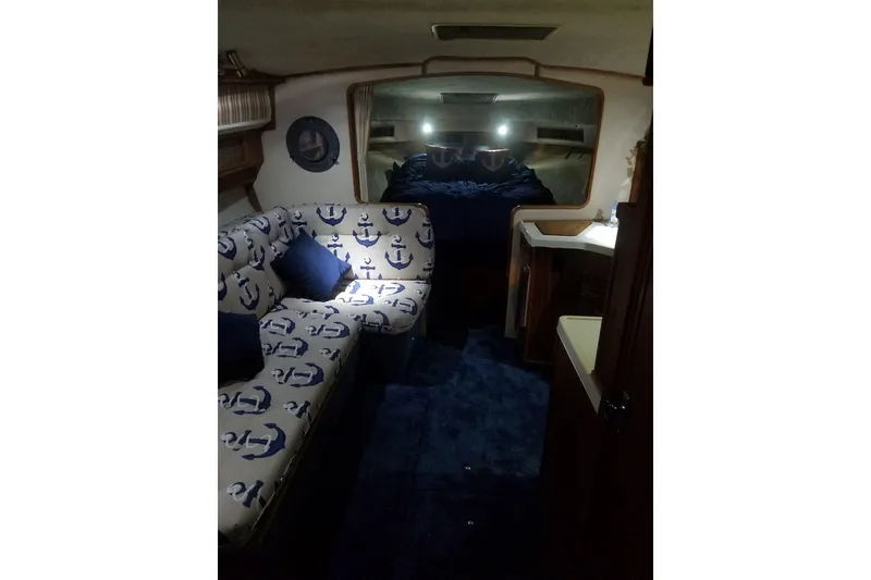 Slide: The Image of Interior of 1986 Sea Ray 340 Sundancer with nautical-themed seating and cozy cabin. - 28