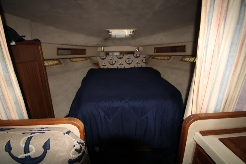 Slide: The Image of 1986 Sea Ray 340 Sundancer interior fridge, open with empty shelves. - 29