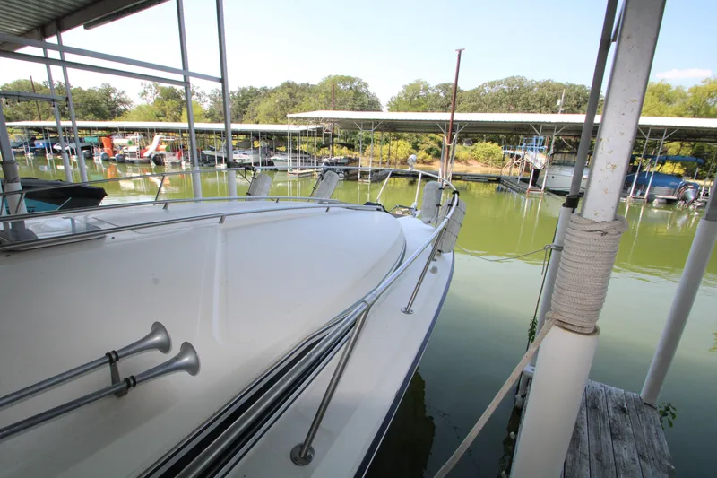 Slide: The Image of 1986 Sea Ray 340 Sundancer docked in a serene marina setting. - 36