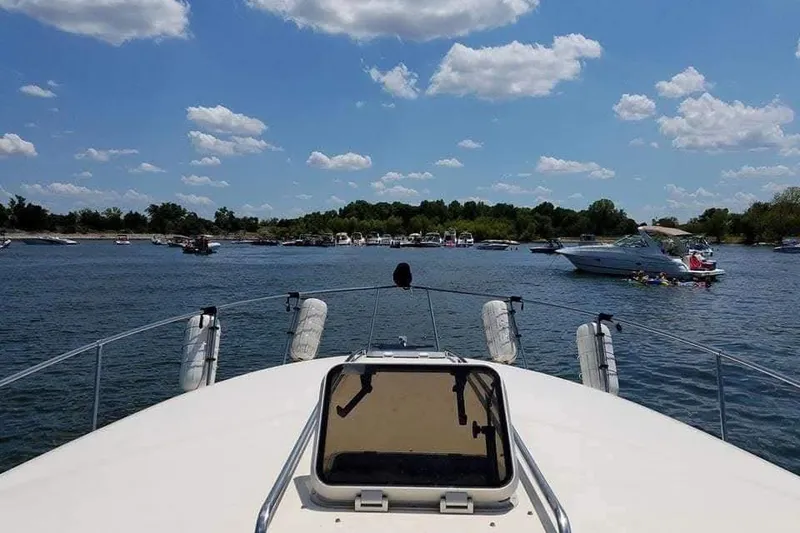 Slide: The Image of Man diving off 1986 Sea Ray 340 Sundancer yacht in open water. - 41