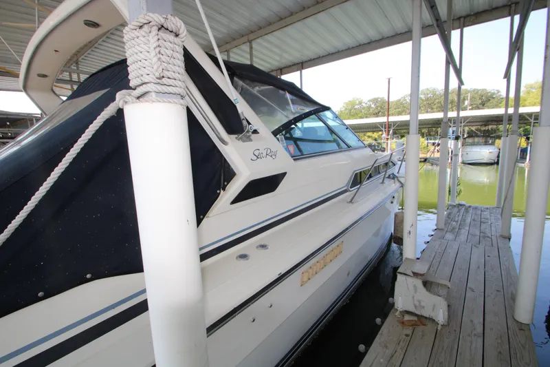Slide: The Image of 1986 Sea Ray 340 Sundancer docked, rear view with cover, named "Fernweh". - 8