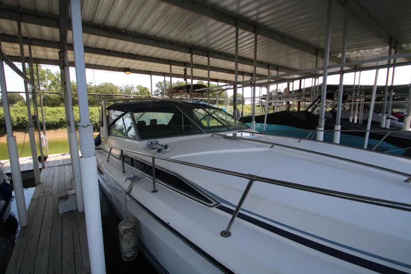Slide: The Image of 1986 Sea Ray 340 Sundancer docked under covered marina. - 9