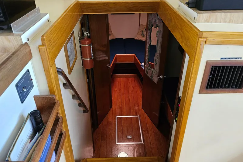 Slide: The Image of 1989 Breaux Brothers Sportfisherman interior with wooden flooring and cozy cabin space. - 20