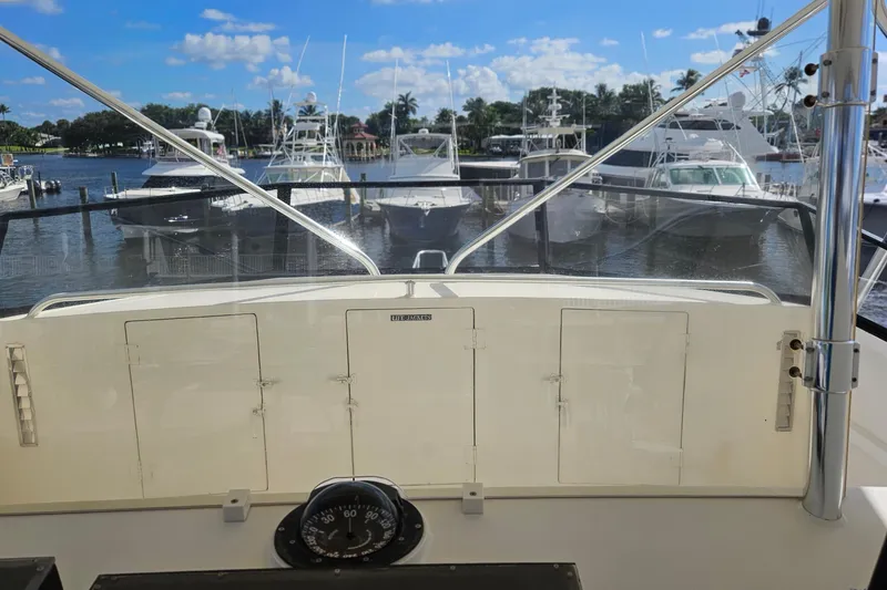 Slide: The Image of 1989 Breaux Brothers Sportfisherman boat docked at marina, clear sky, calm water. - 38