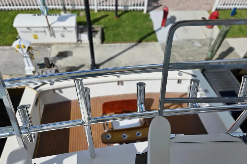 Slide: The Image of 1989 Breaux Brothers Sportfisherman boat deck with chrome railings and wooden flooring. - 40