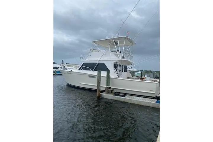Slide: The Image of 1989 Breaux Brothers 42 Sportfisherman docked under cloudy skies. - 6
