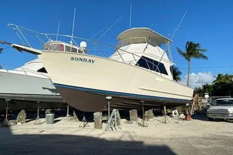 Slide: The Image of 1989 Breaux Brothers 42 Sportfisherman boat named "Sunday" on dry dock under clear blue sky. - 7