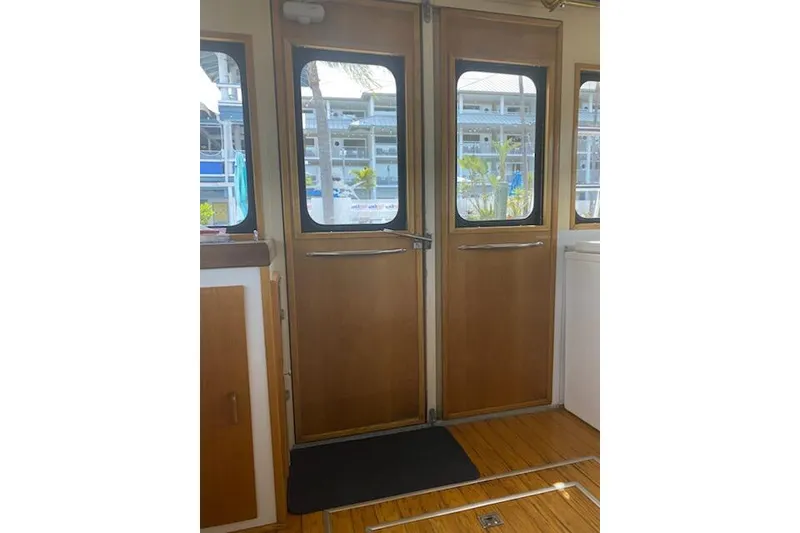 Slide: The Image of Interior view of 1989 Breaux Brothers 42 Sportfisherman, featuring wooden doors and windows. - 8