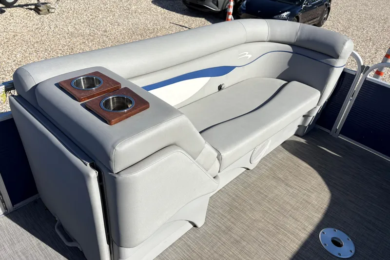 Slide: The Image of Storage compartment on a 2021 Bennington 24 SVRC boat with a Hefty container inside. - 10