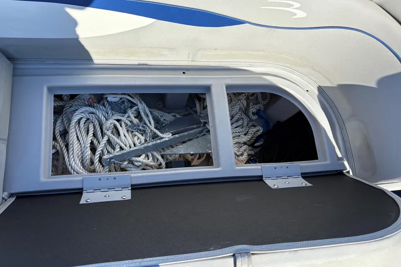 Slide: The Image of 2021 Bennington 24 SVRC pontoon boat interior with gray seating and cup holders. - 11