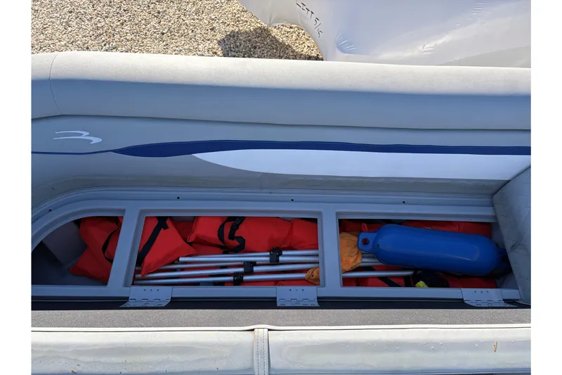 Slide: The Image of Storage compartment with ropes and anchor on a 2021 Bennington 24 SVRC boat. - 13