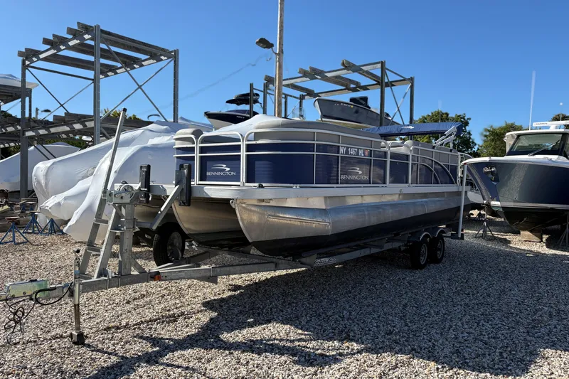 Slide: The Image of 2021 Bennington 24 SVRC pontoon boat on trailer in outdoor storage area. - 18