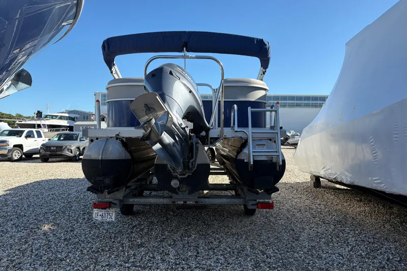 Slide: The Image of 2021 Bennington 24 SVRC pontoon boat on a trailer, outdoors, with "Trailer Not Included" text. - 2