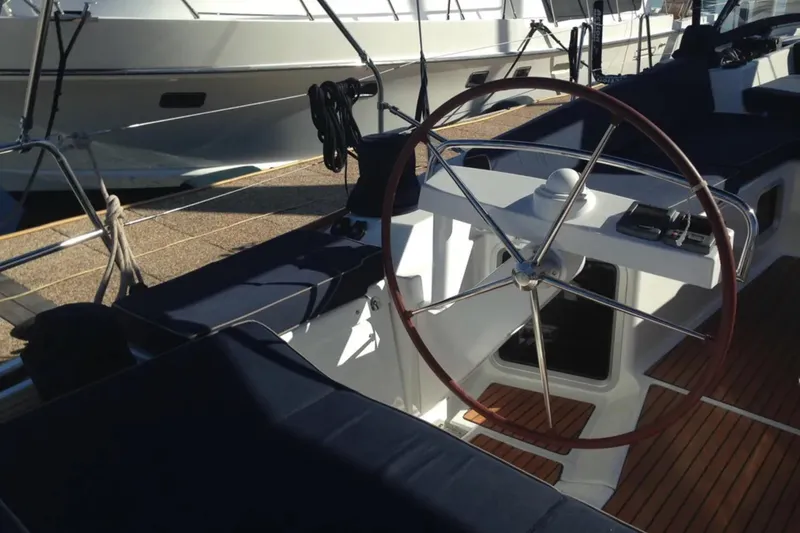 Slide: The Image of Cockpit of 2011 Jeanneau 57 sailboat with wooden deck and steering wheel. - 17