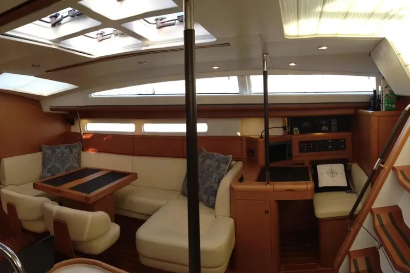 Slide: The Image of Luxurious interior of a 2011 Jeanneau 57 yacht with elegant seating and navigation area. - 25