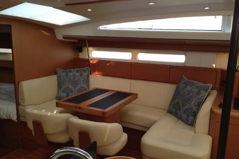 Slide: The Image of Luxurious interior of a 2011 Jeanneau 57 yacht with elegant seating and wooden accents. - 26