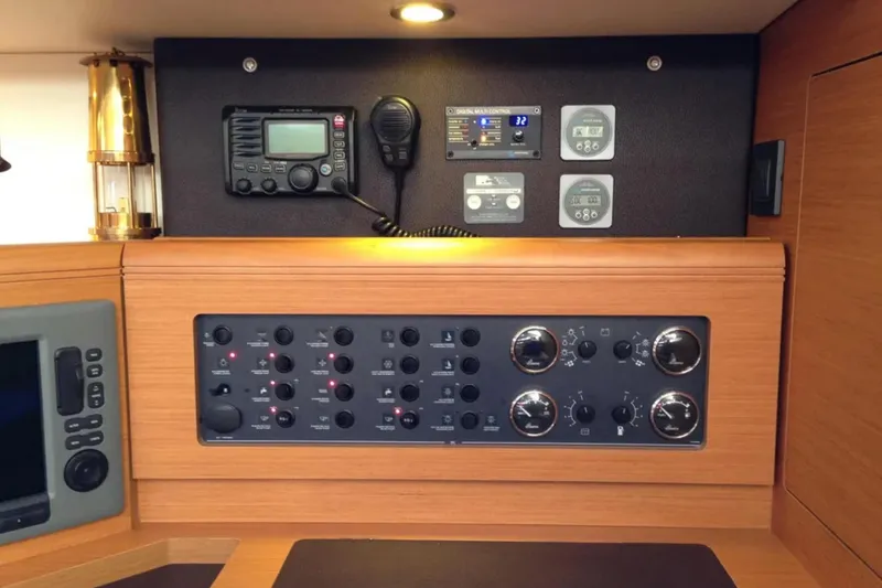 Slide: The Image of Control panel of a 2011 Jeanneau 57 yacht, featuring navigation and communication equipment. - 29