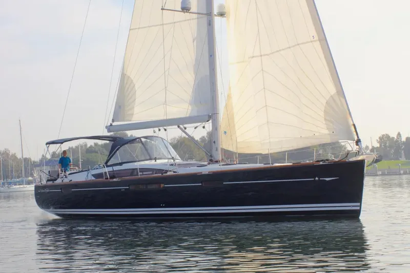 Slide: The Image of 2011 Jeanneau 57 sailboat cruising on calm waters with sails fully raised. - 3