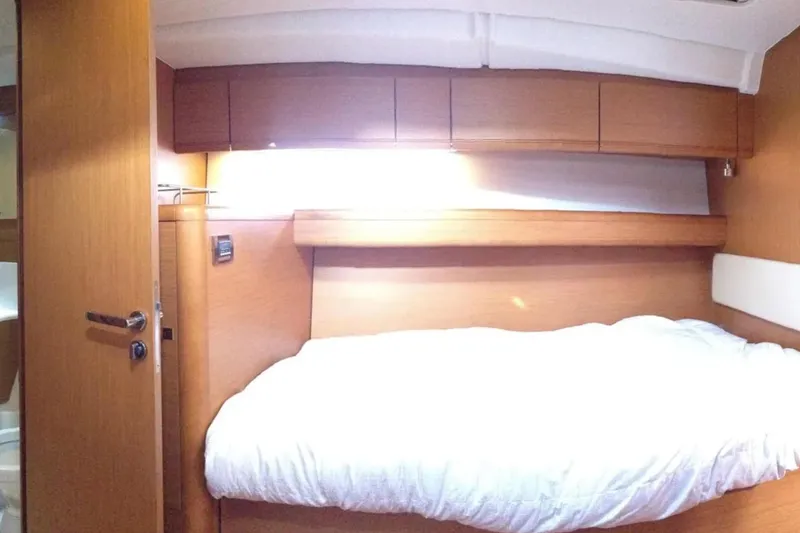 Slide: The Image of Interior cabin of a 2011 Jeanneau 57 yacht with wooden finish and cozy bed. - 41