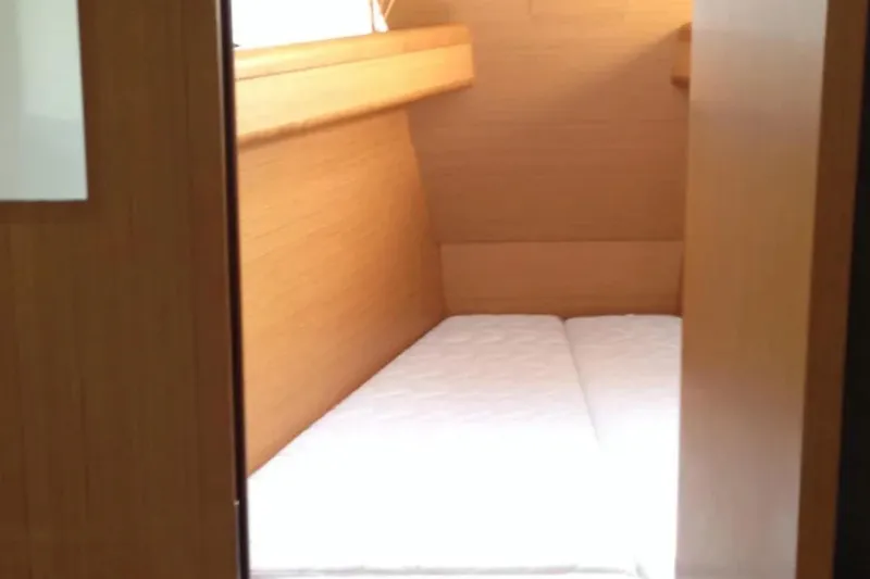 Slide: The Image of Interior cabin of 2011 Jeanneau 57 yacht with wooden finish and mattress. - 44