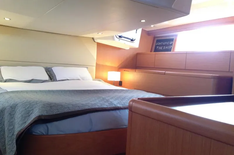 Slide: The Image of Luxurious bedroom interior of 2011 Jeanneau 57 yacht with cozy bedding and ambient lighting. - 48