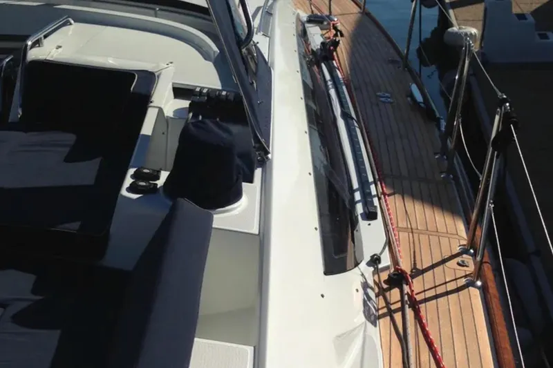 Slide: The Image of 2011 Jeanneau 57 yacht deck with seating and wooden flooring. - 8