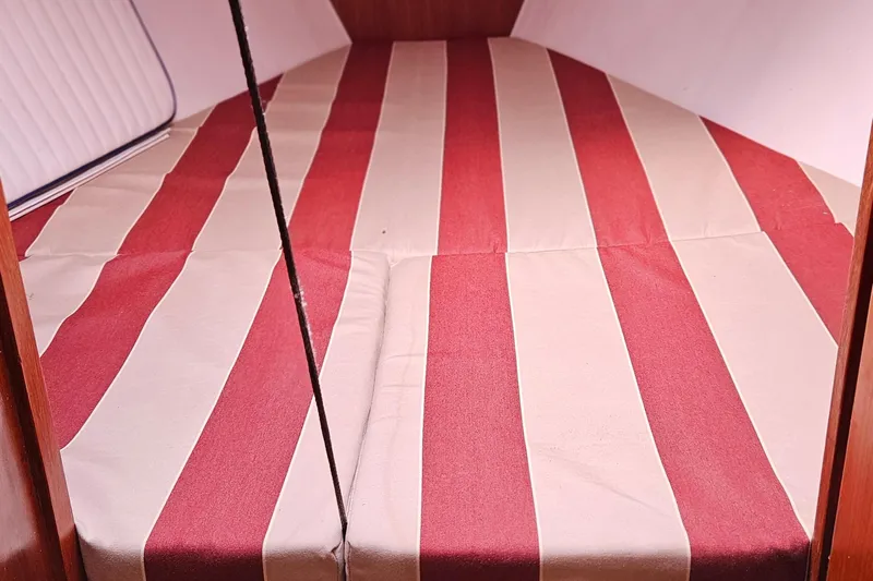 Slide: The Image of Red and white striped bedding in 1977 Peterson 34 Sloop cabin. - 20