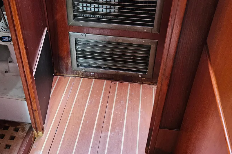 Slide: The Image of Interior of 1977 Peterson 34 Sloop with wooden flooring and vented panel. - 21
