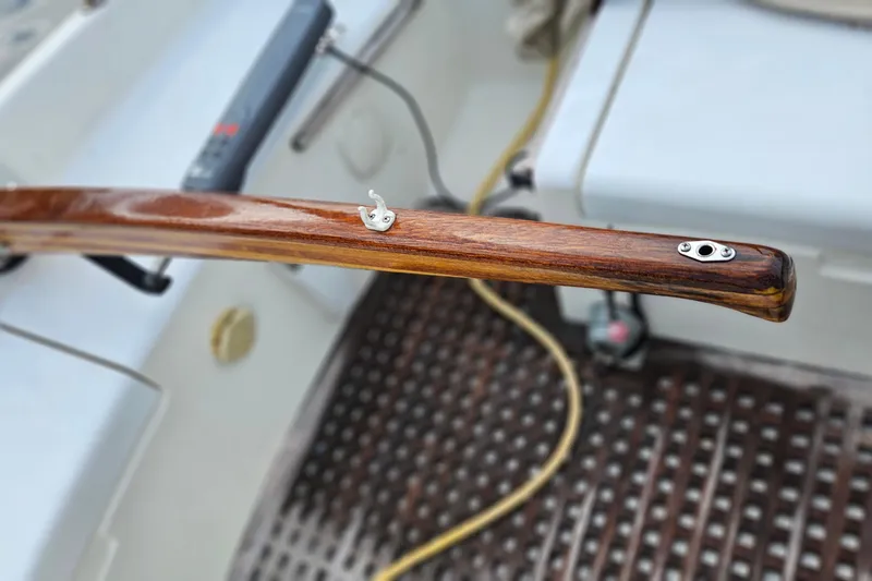Slide: The Image of Wooden tiller of a 1977 Peterson 34 Sloop, showcasing detailed craftsmanship. - 38