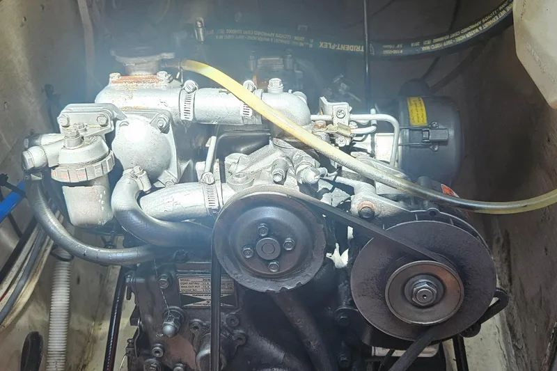 Slide: The Image of Engine of a 1977 Peterson 34 Sloop sailboat, showcasing mechanical components and belts. - 44