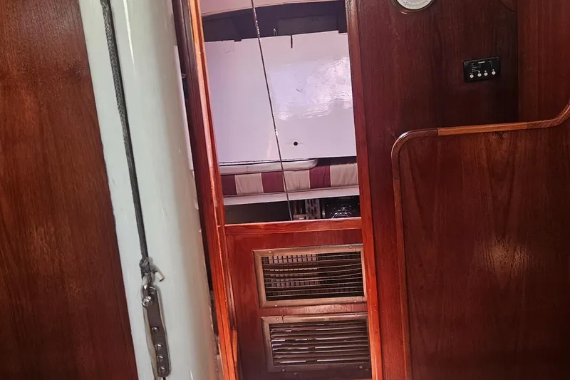 Slide: The Image of Interior view of 1977 Peterson 34 Sloop, featuring wooden paneling and cabin details. - 45