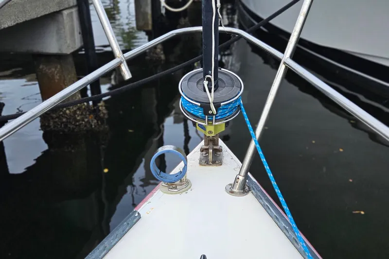 Slide: The Image of Bow of 1977 Peterson 34 Sloop with blue rope and dock view. - 7