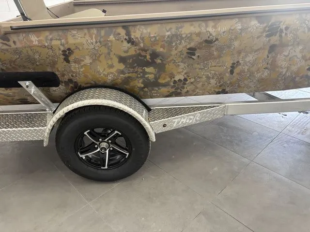 Slide: The Image of 2026 Thor 1754 Timber Hammer boat with camouflage pattern on trailer. - 21