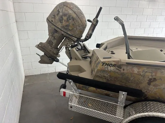 Slide: The Image of 2026 Thor 1754 Timber Hammer boat on trailer parked outdoors. - 5